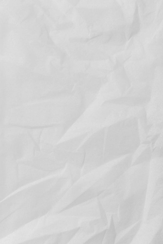 white textile on brown wooden table