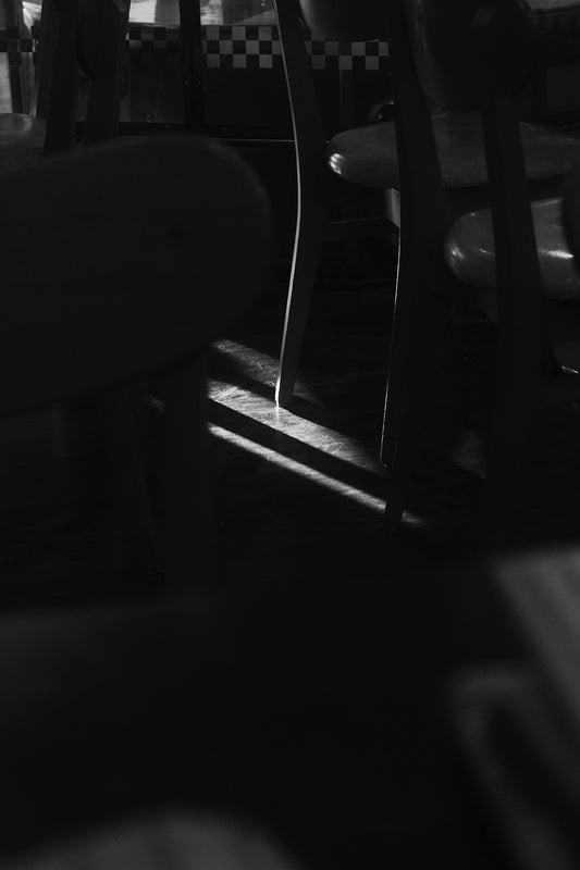 a black and white photo of chairs and a table