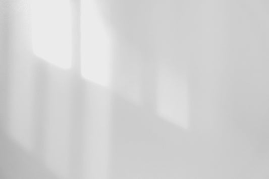 a black and white photo of a white wall
