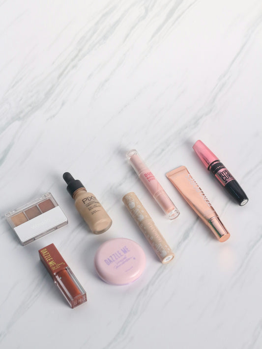 a white marble counter top with various cosmetics and makeup products