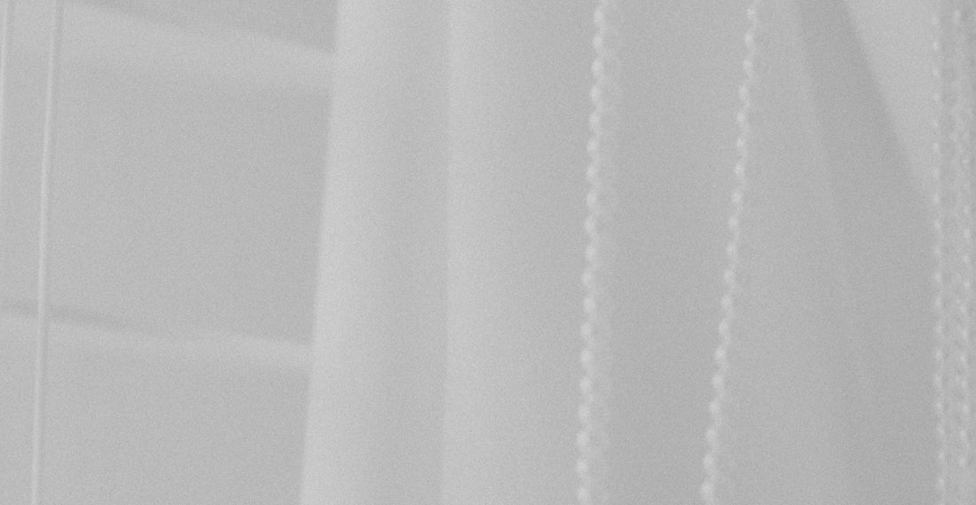 a black and white photo of a white curtain