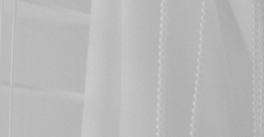 a black and white photo of a white curtain