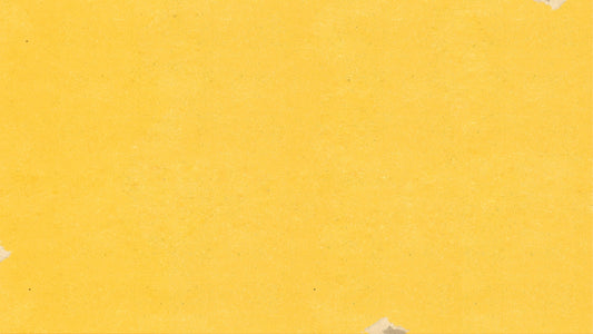 a piece of yellow paper with torn edges