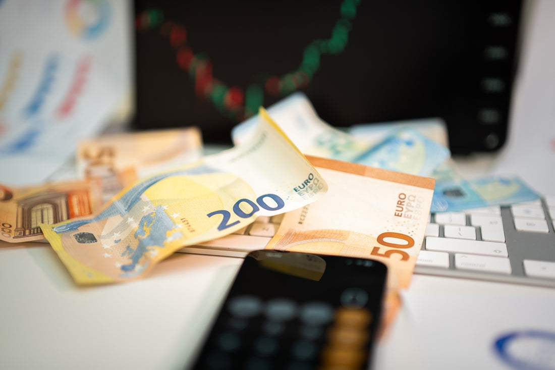A cell phone sitting on top of a pile of money
