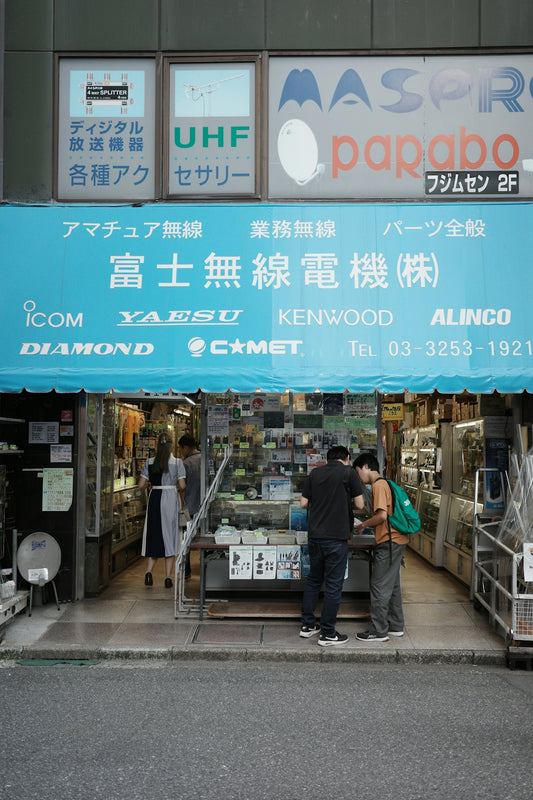 A group of people standing outside of a store