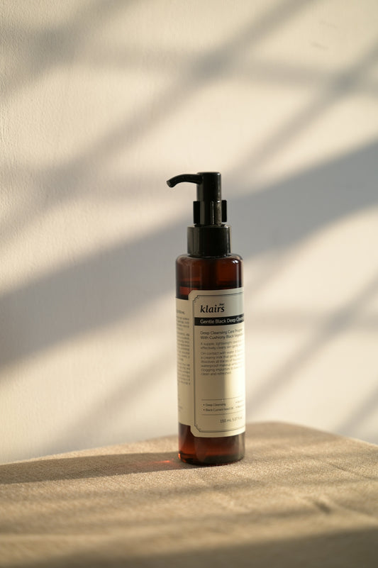 Bottle of skincare product on a table.