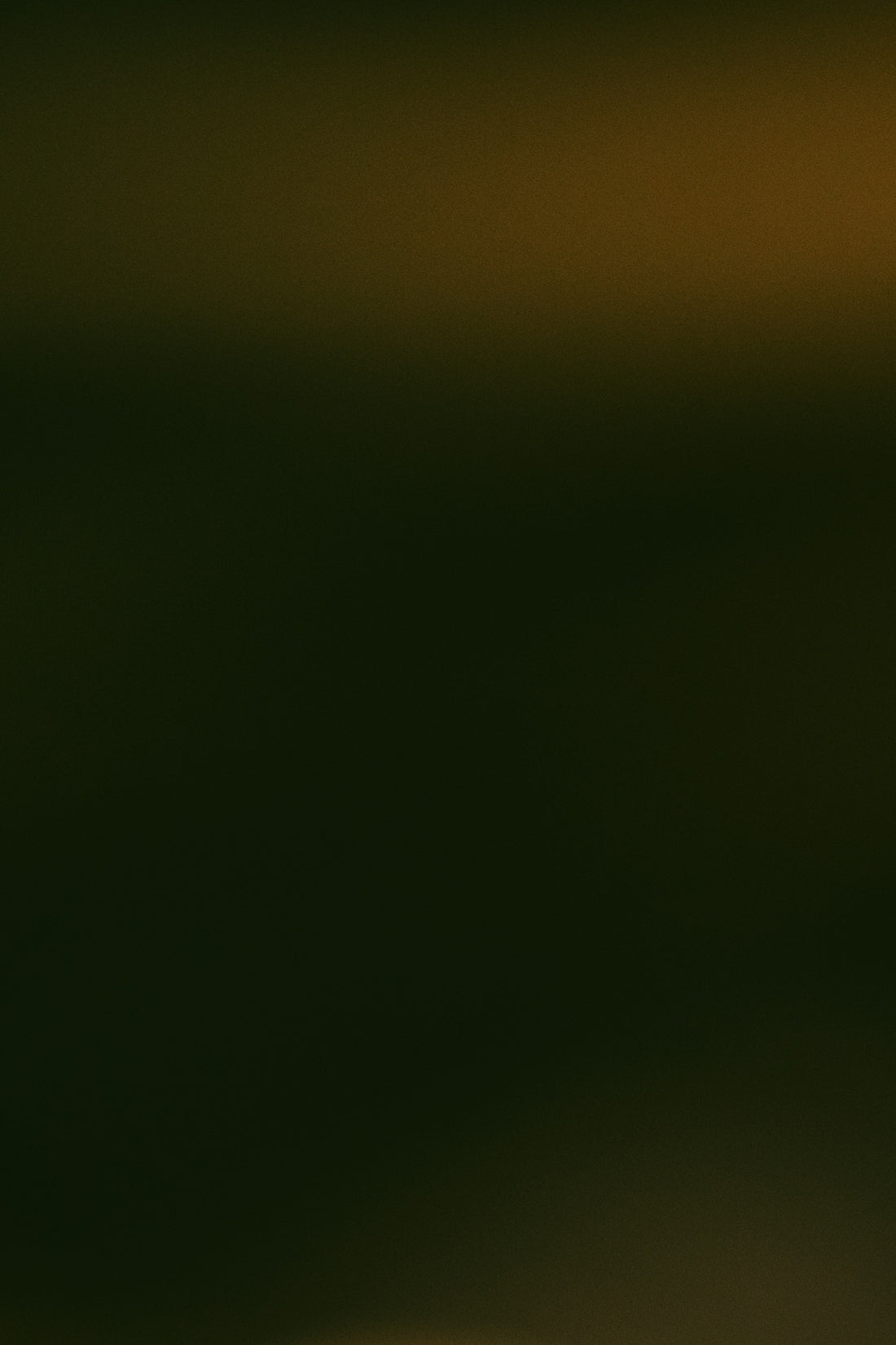 Dark abstract background with subtle warm light.