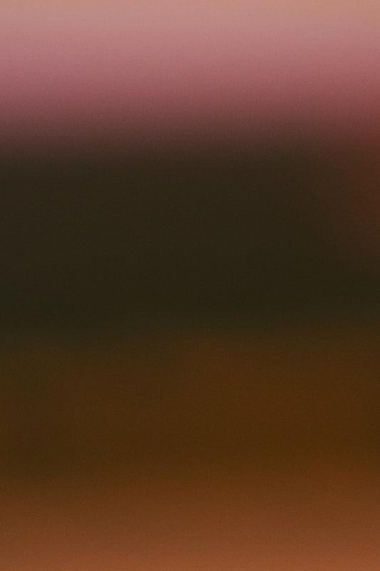 A soft gradient of brown and pink hues.