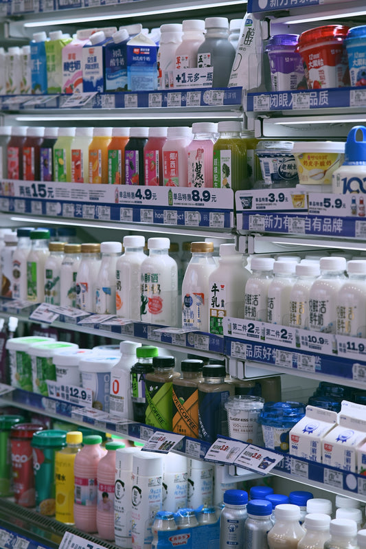 Shelves stocked with various dairy products and drinks.
